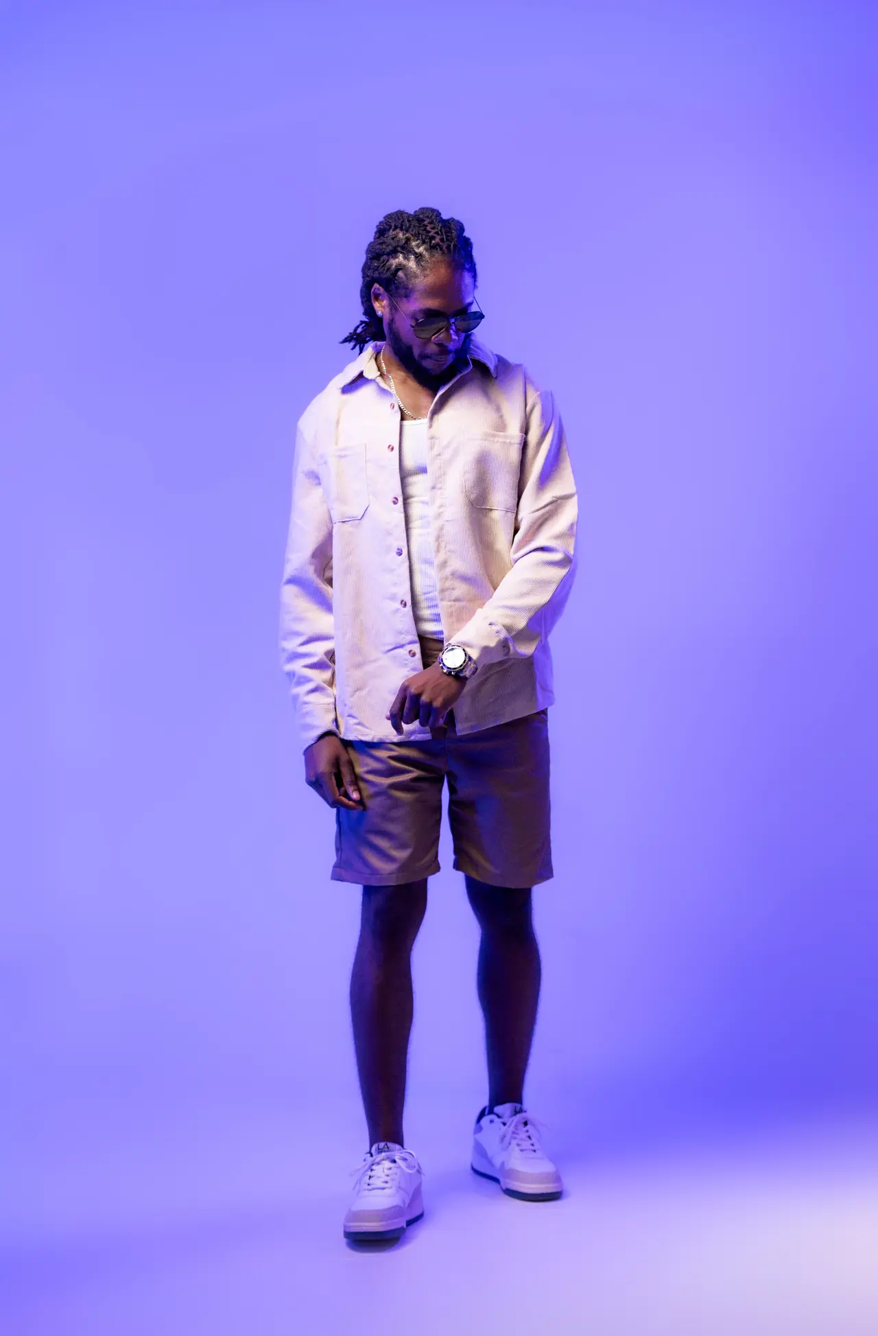 Saint Chris full-body editorial portrait in blue studio light.